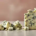 Close-up of blue cheese crumbles on a smooth surface