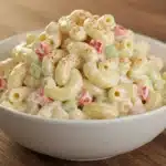 Creamy classic macaroni salad in white bowl