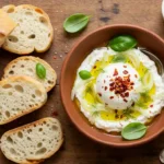 Creamy Stracciatella Cheese with chili crisp and fennel served with ciabatta bread