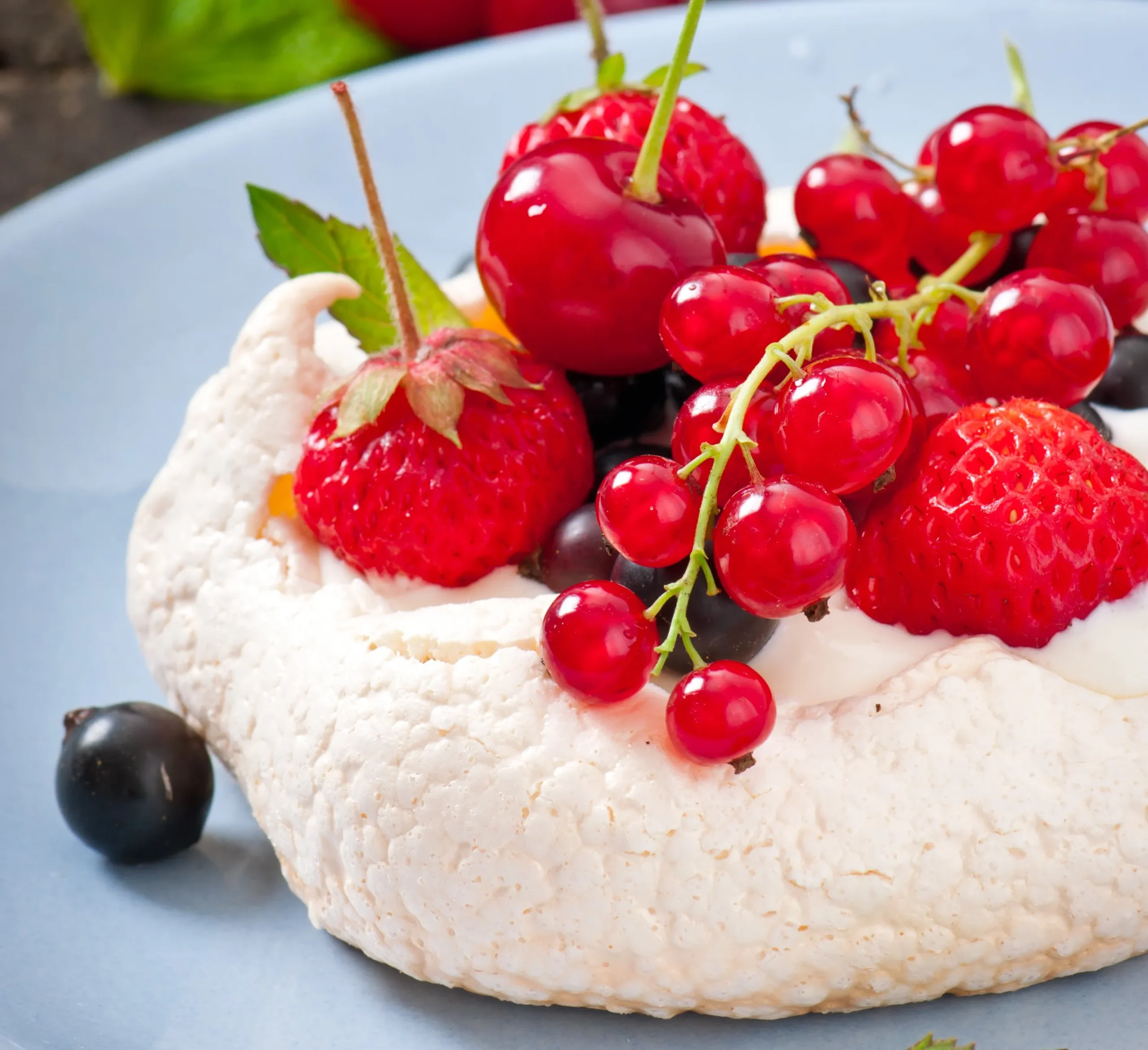 A variety of cottage cheese desserts, including cheesecake, pudding, and a fruit bowl, arranged on a table.
