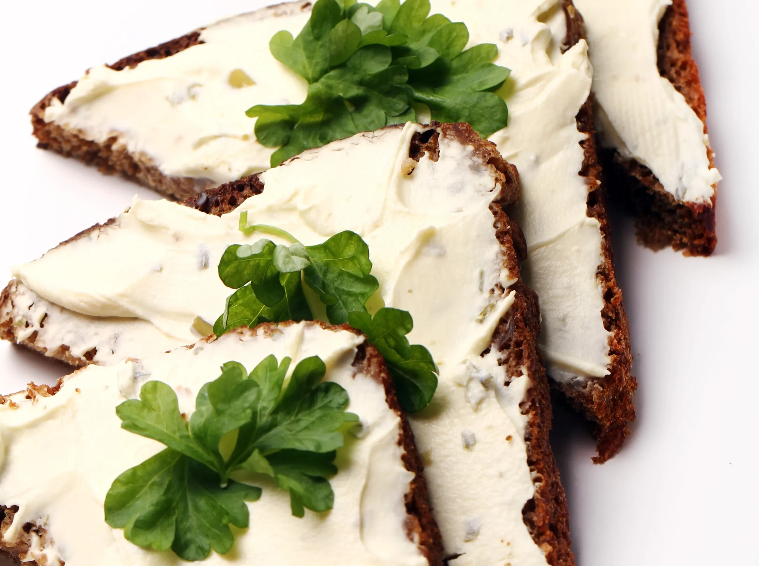 A platter of goat cheese appetizers with honey, nuts, and herbs