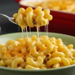 A creamy, golden macaroni and cheese bowl topped with crispy panko breadcrumbs, served in a white dish.