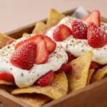Strawberry Cheesecake Nachos with cream and strawberries in tray