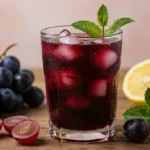Glass of homemade grape riot with ice and mint
