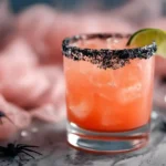 Hallow-Rita Margarita with red wine float, lime garnish, and Halloween decor