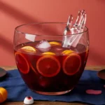 Halloween Vampire Punch bowl with garnishes on coral and blue table